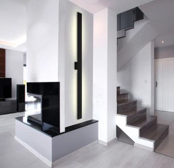 Modern interior with a staircase and black vertical wall light.