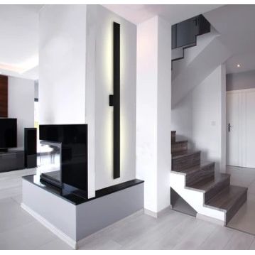Modern interior with a staircase and black vertical wall light.