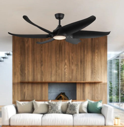 Black ceiling fan in a living room with a wooden wall and sofa.