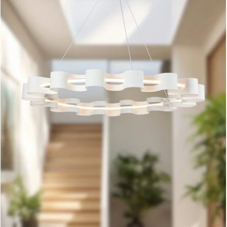 Modern chandelier hanging in a room with plants and neutral decor