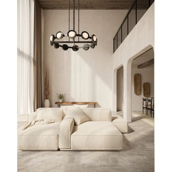 Modern living room with a chandelier, sofa, and decorative elements.