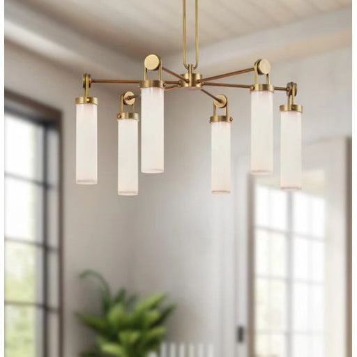 Modern chandelier with gold fixtures and white glass shades in a room with large windows.