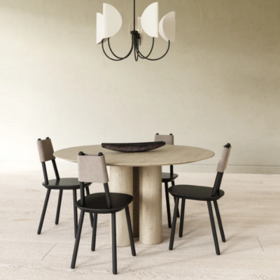 White cotton shades on black metal 5 armed chandelier over a dining room table