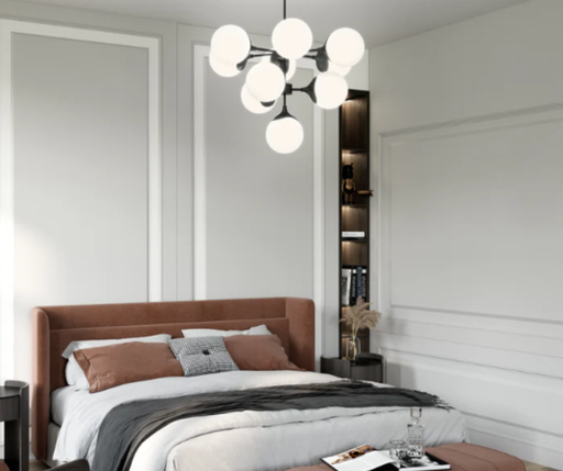 Modern chandelier with white glass shades and black metal frame over a mauve bed