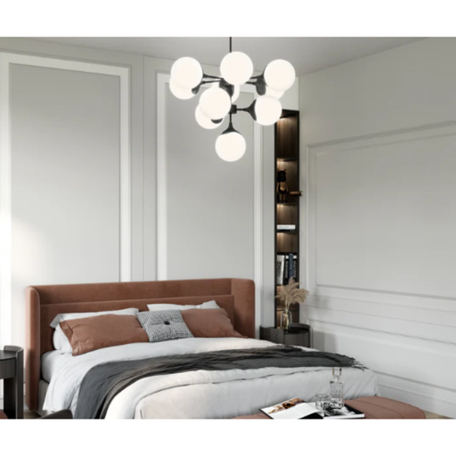 Modern chandelier with white glass shades and black metal frame over a mauve bed
