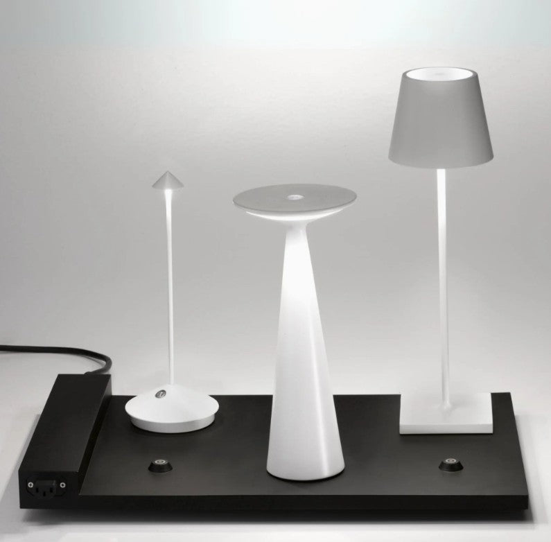 Three different table lamps on a black platform with a white background