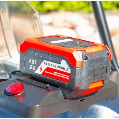 Tomahawk Power eTOS22 electric sweeper showing triple power brooms and control handle